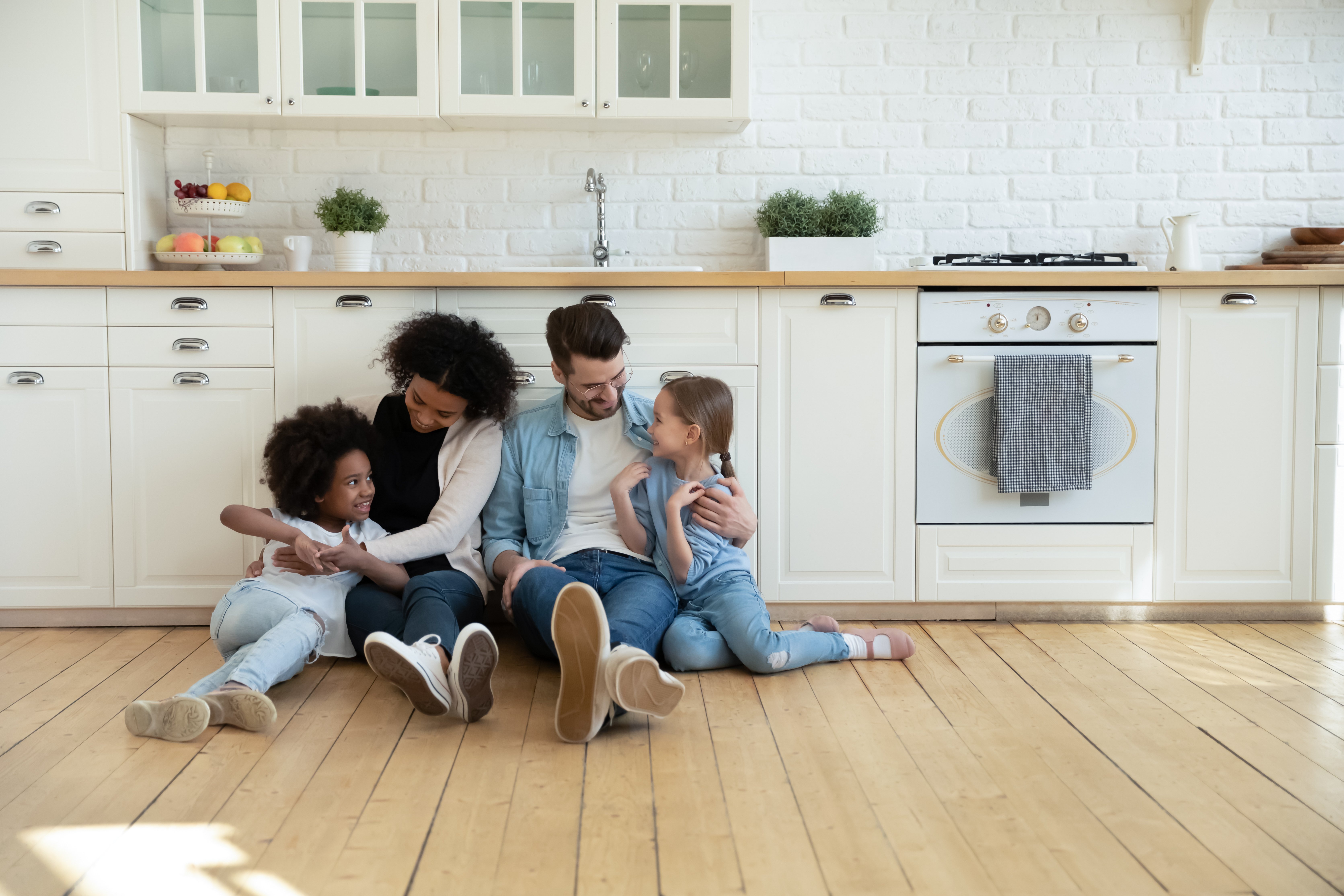 family sitting on kitchen floor